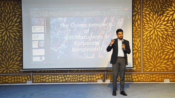 A person standing in front of a projector screen